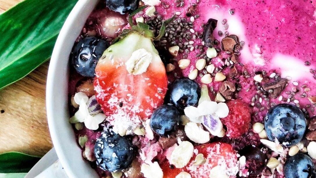 A bowl of mixed berries and seeds.