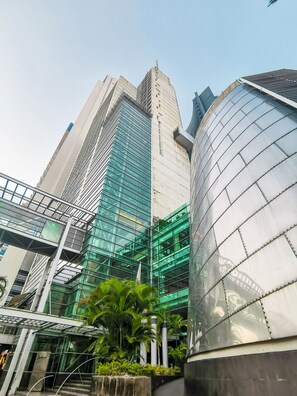 Een modern gebouw met een glazen gevel en een gebogen metalen structuur.