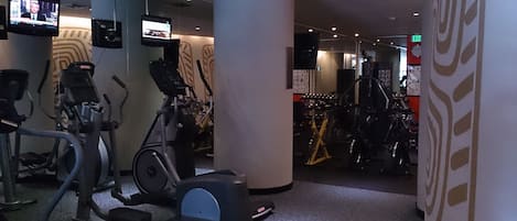 A gym with stationary bikes, treadmills, and exercise equipment.