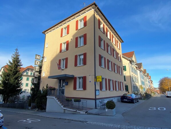 A hotel building with multiple windows and a visible entrance.