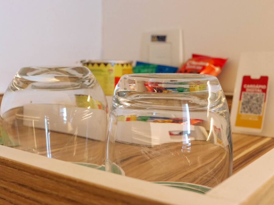 A clear glass container with a wooden frame, possibly a decorative item or a part of a display.
