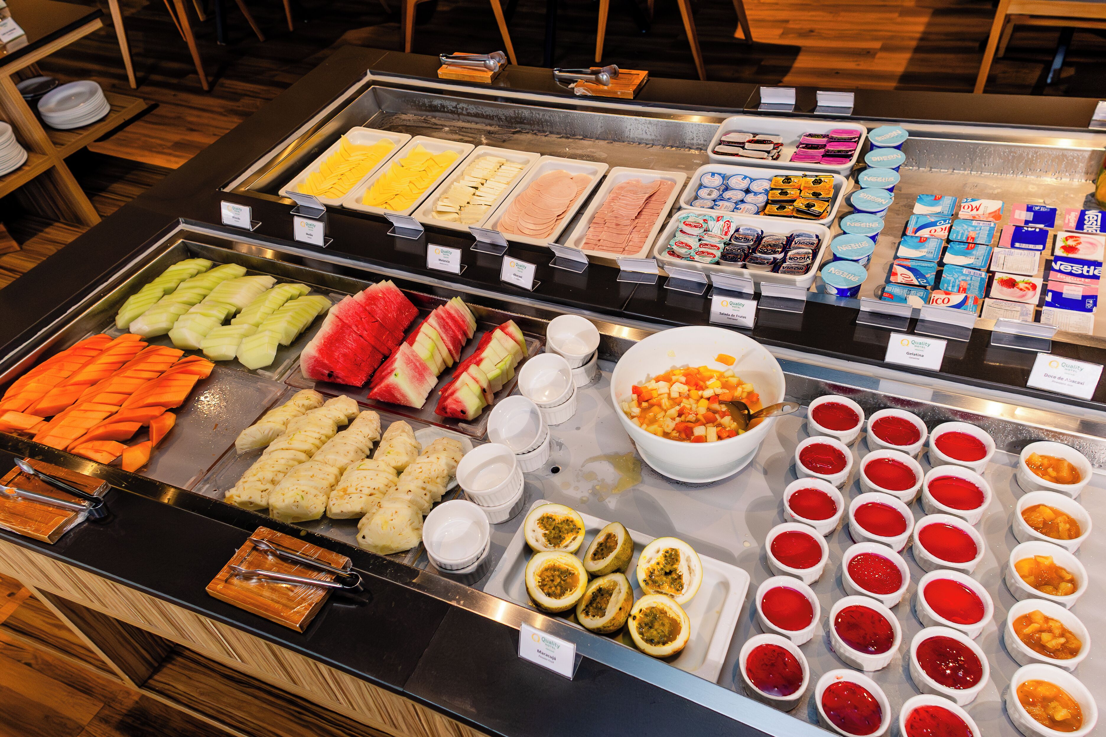 Een buffet met verschillende soorten eten, zoals fruit, groenten en sauzen.
