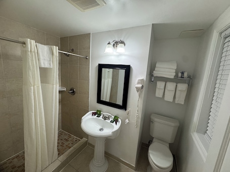 Traditional Room, 2 Full Beds | Bathroom | Shower, free toiletries, hair dryer, towels. District Hotel