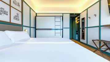 A bedroom with a bed, a ladder, a desk, and a wardrobe.