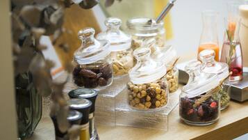 A shelf with various glass containers holding different food items.