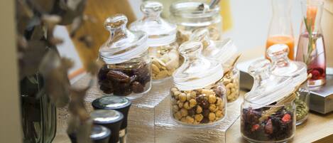 A shelf with various glass containers holding different food items.
