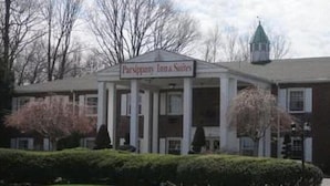 A building with a sign reading "Parsonage Inn Suites". - Parsippany Inn and Suites Morris Plains (Morris Plains)