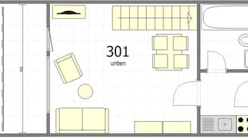 Plano de distribución de una habitación de hotel que incluye una cama, un escritorio, una silla, una mesita, un sofá, un área de estar circular, un baño con bañera, lavabo y estufa.