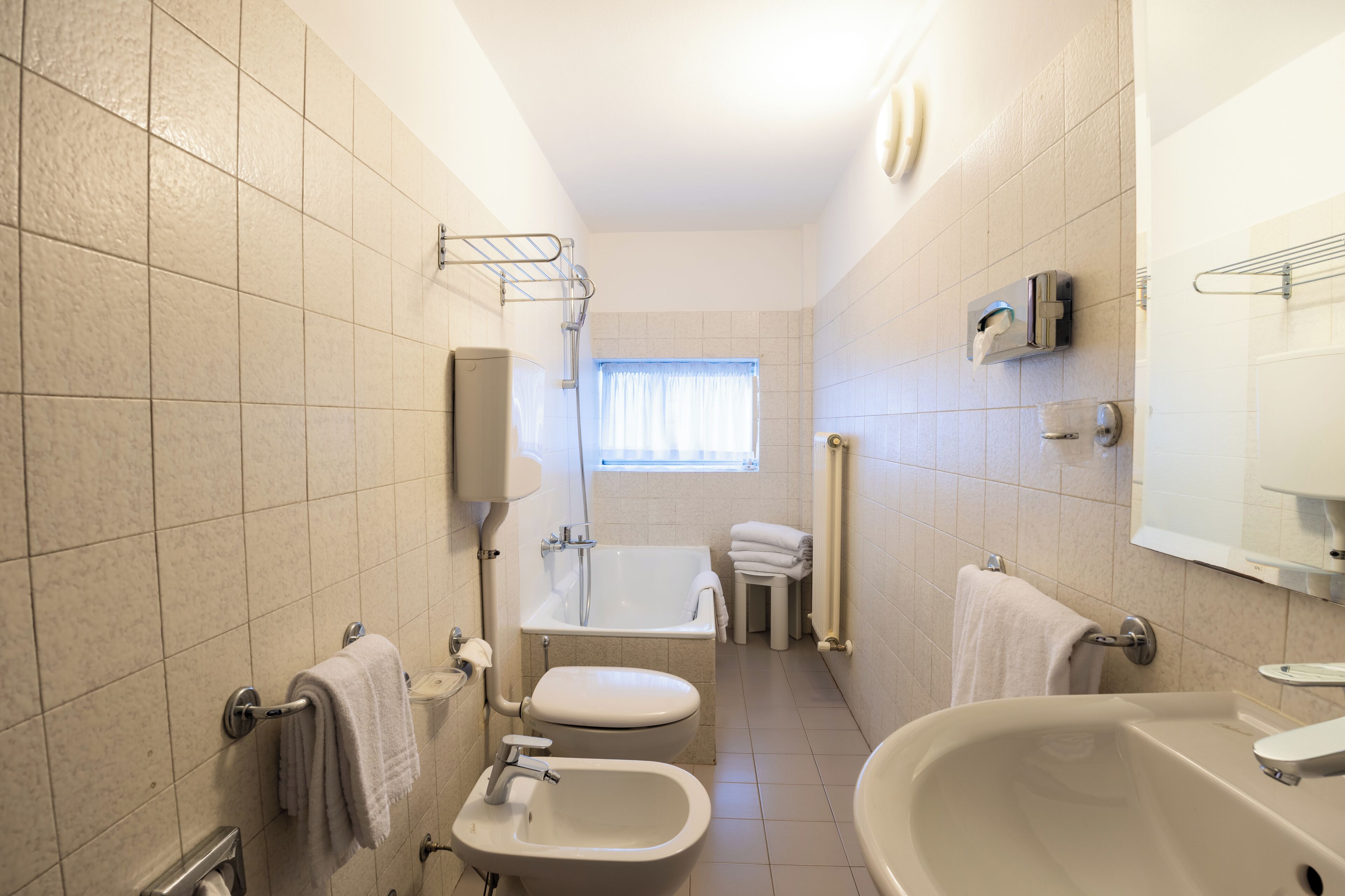 standard quadruple room | bathroom | rainfall showerhead, hair dryer, bidet, towels