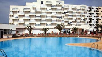 A swimming pool with a modern building in the background.