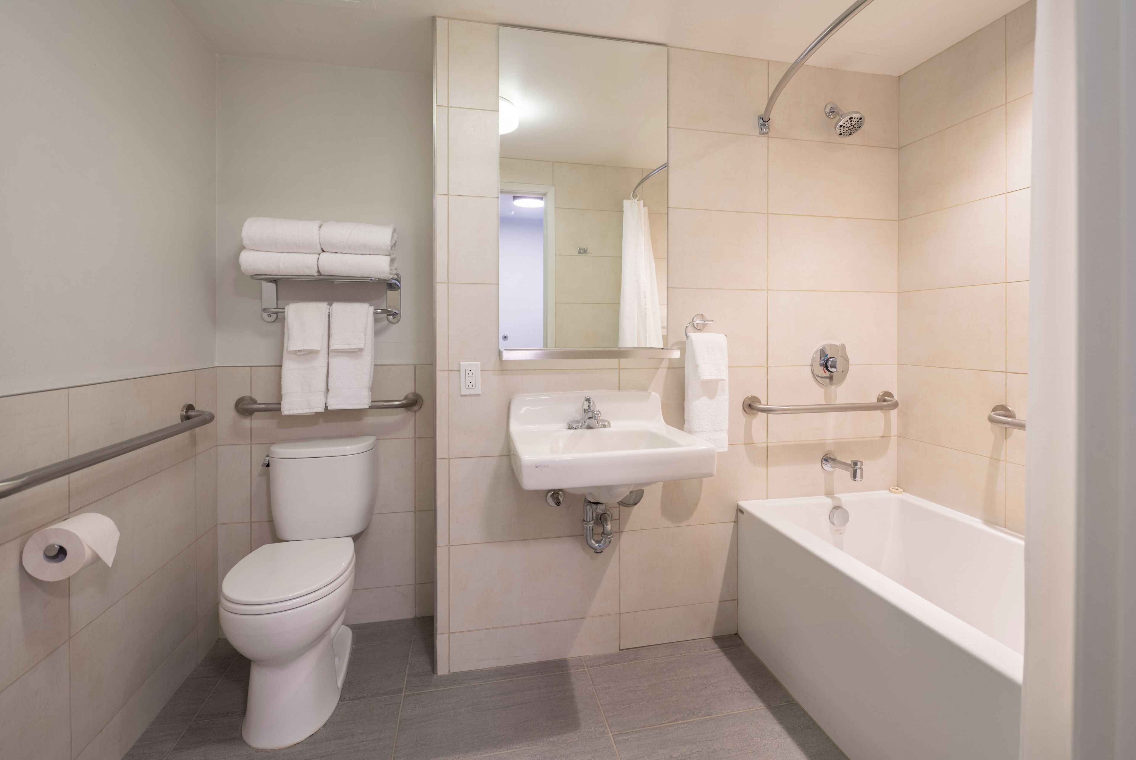 A bathroom with a toilet, sink, and bathtub.