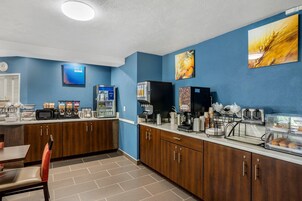A hotel kitchen with a coffee station, a microwave, and a toaster.