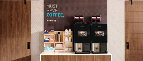 A coffee station with two espresso machines, a coffee grinder, and various coffee-related items.