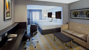 A hotel room with a bed, a sofa, a desk, and a chair. - Holiday Inn Express & Suites Cooperstown by IHG (Cooperstown)