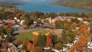 Un barrio residencial con casas, un campo de béisbol y un lago.