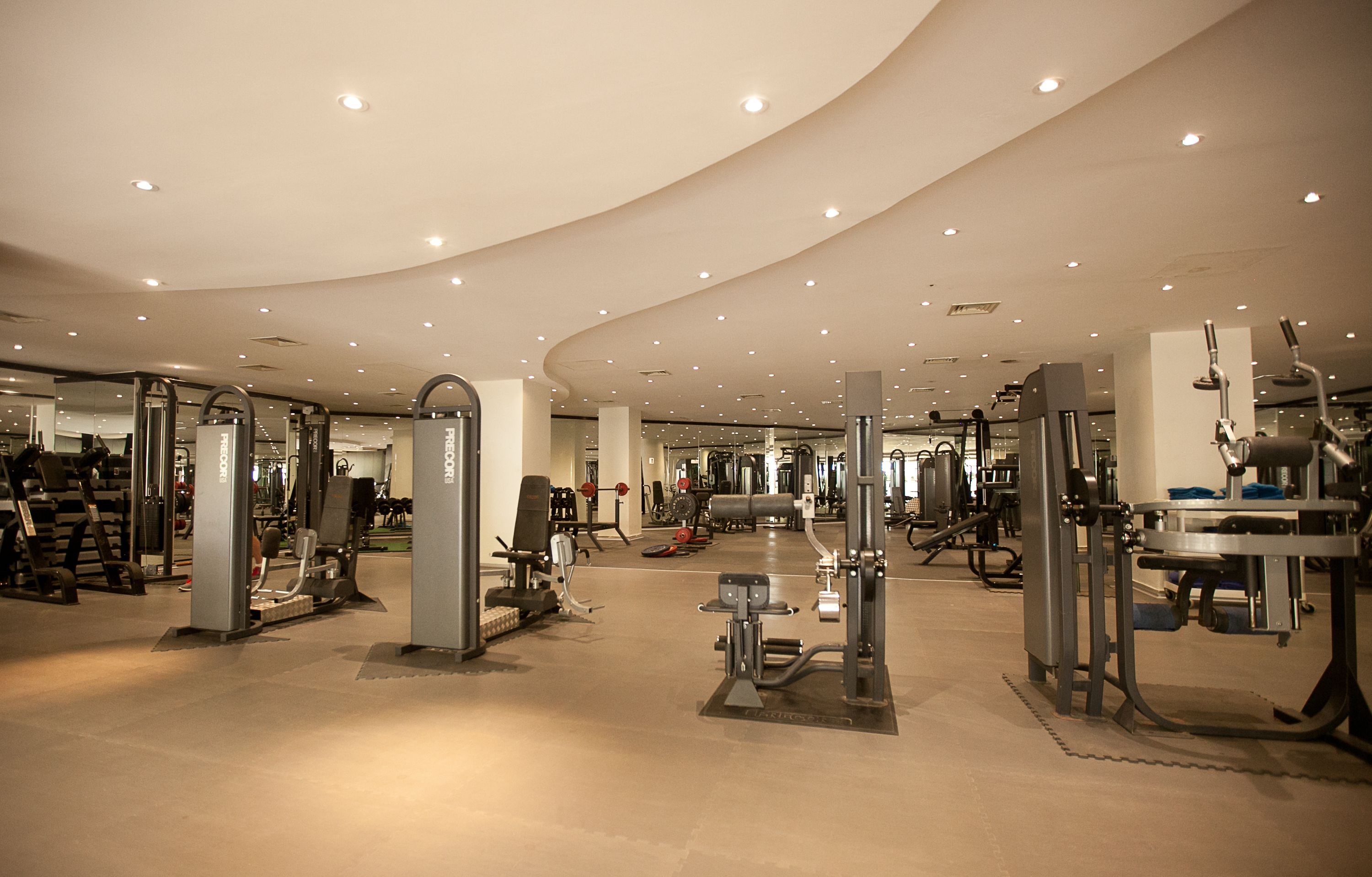 A spacious gym with various exercise machines and equipment.