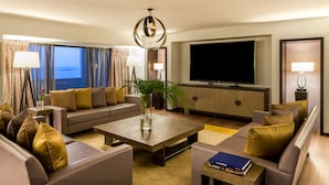A modern hotel room with a sofa set, a coffee table, a TV, and a large window with curtains. - Eko Hotel Main Building (Lagos)