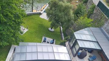 Une piscine sur le toit, dotée de chaises longues et d’une terrasse fermée par des baies vitrées.