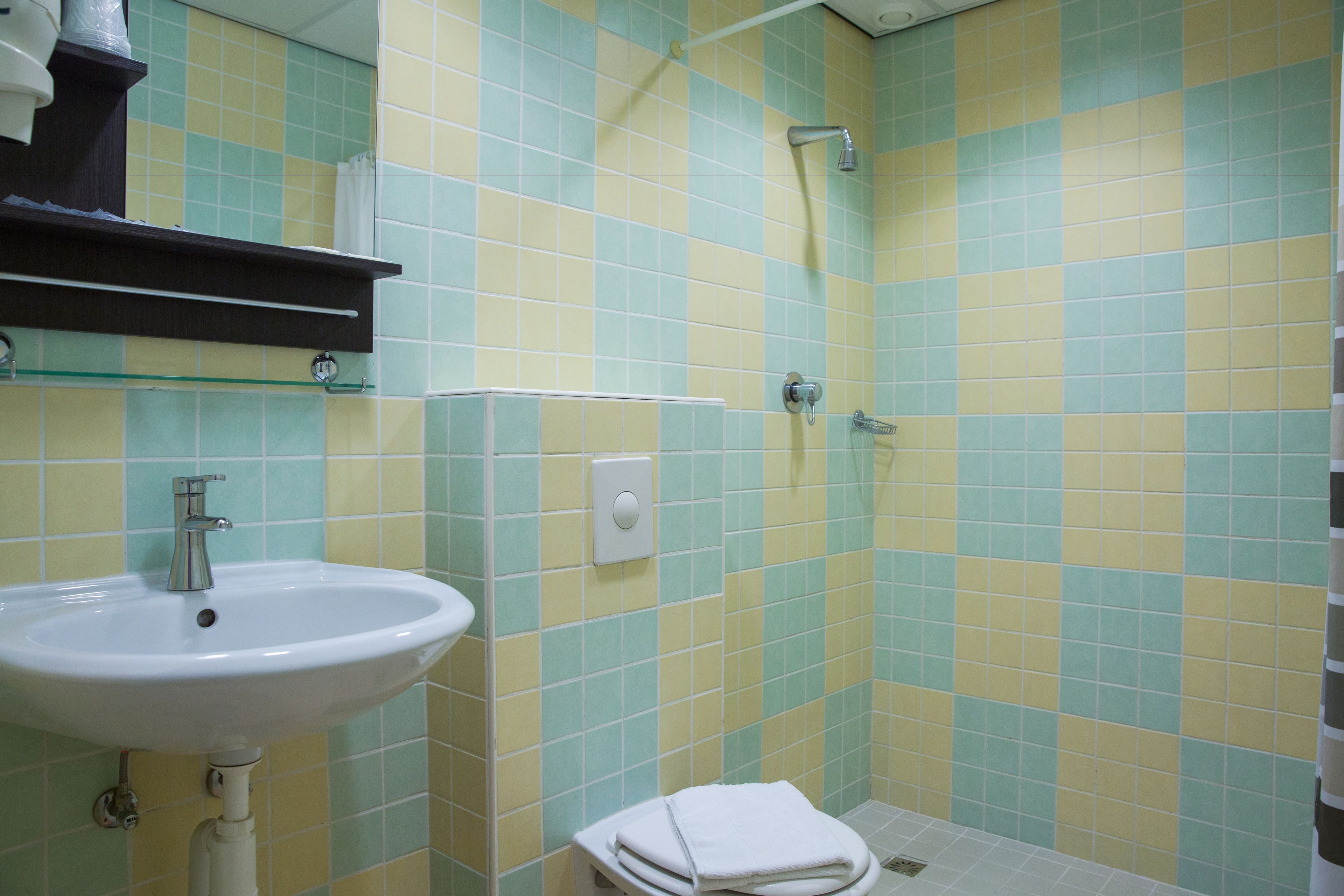 A bathroom with a sink, a shower, and a toilet.