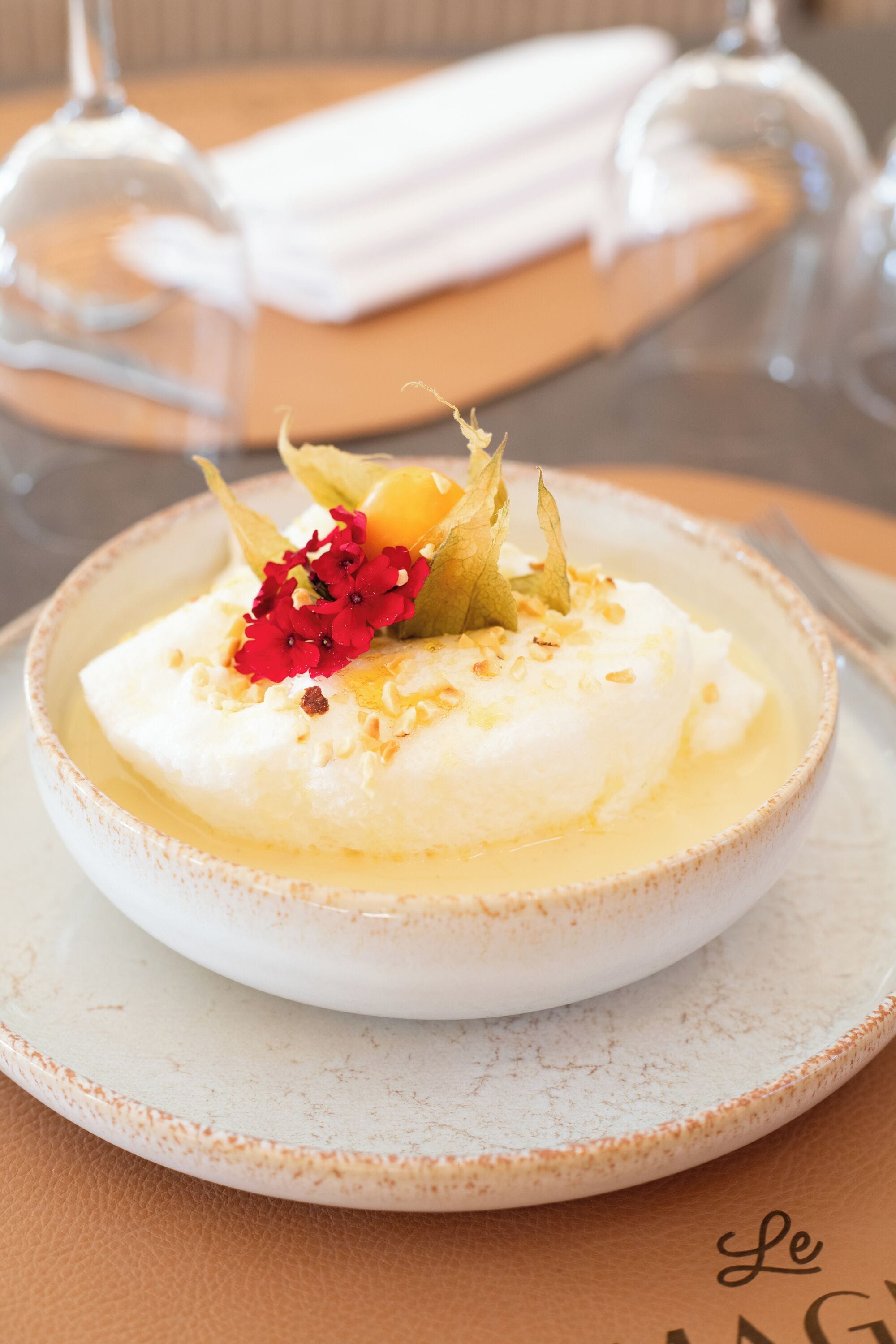 A dessert on a plate with a napkin and glass in the background.