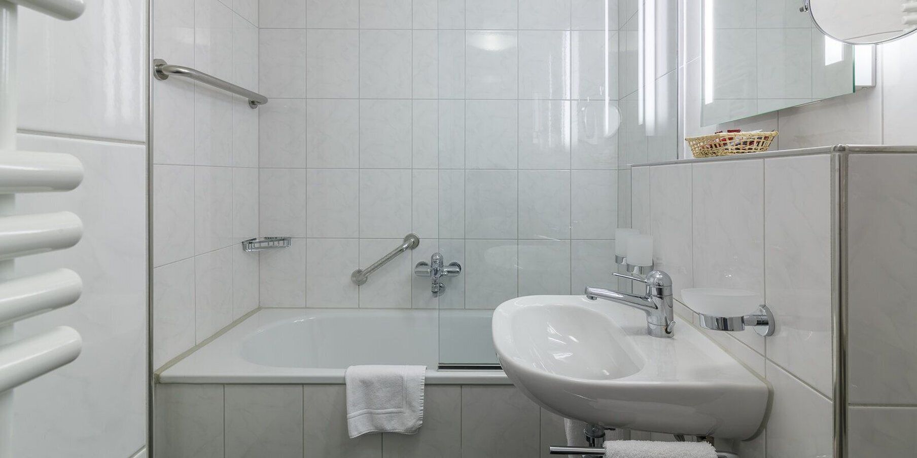 Un bagno moderno con vasca, lavabo e zona doccia.