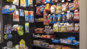 A snack aisle with various packaged snacks and a small toy display. - Baymont by Wyndham Fulton (Fulton)
