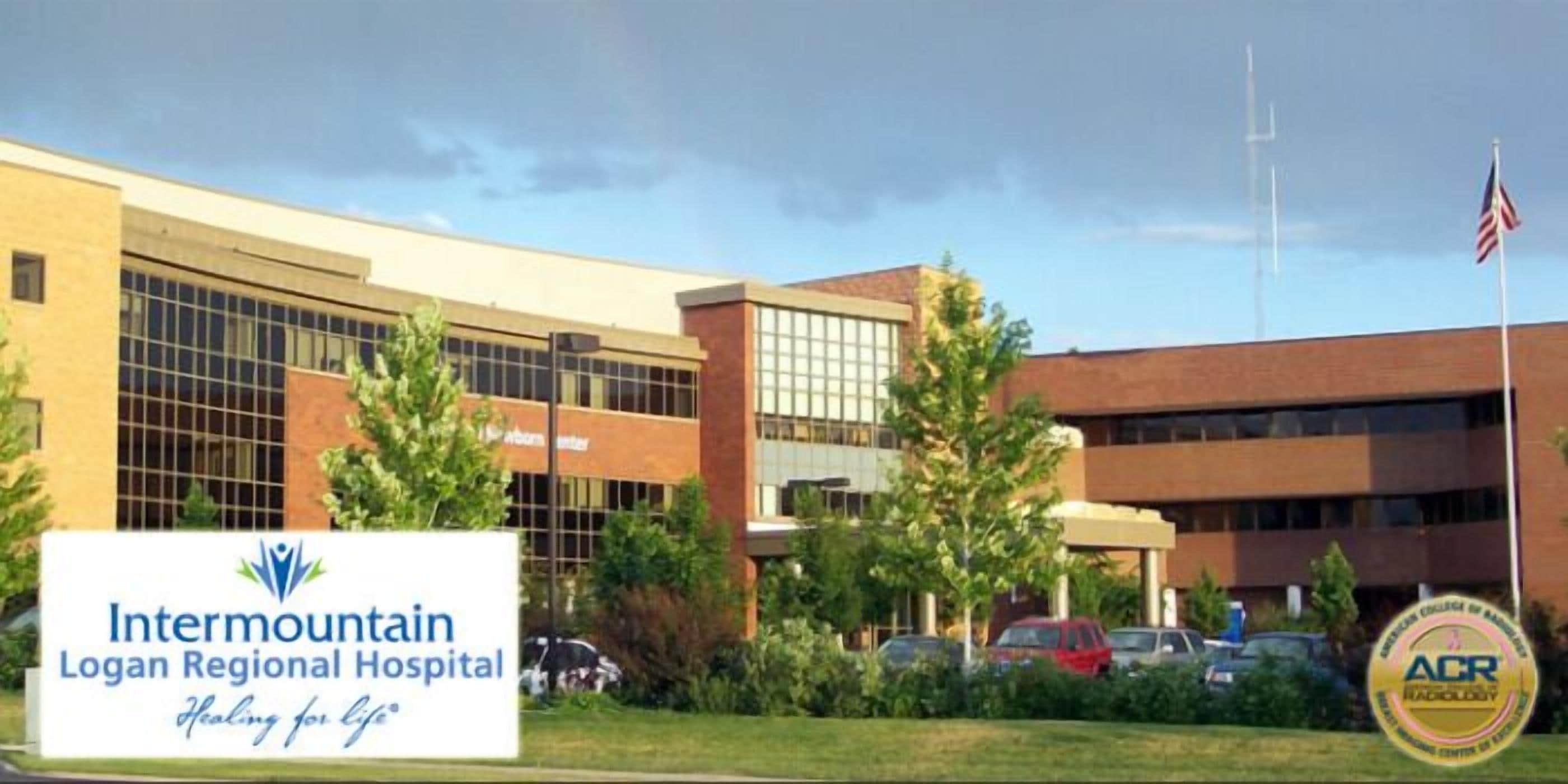 Intermountain Logan Regional Hospital with a signboard, parking area, and American flag.