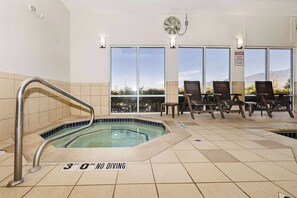 A 3'0" no diving indoor pool with a view of mountains through large windows.
