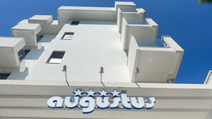 A building with a modern architectural style, featuring a prominent sign with a logo and text. - Hotel Augustus (Riccione)