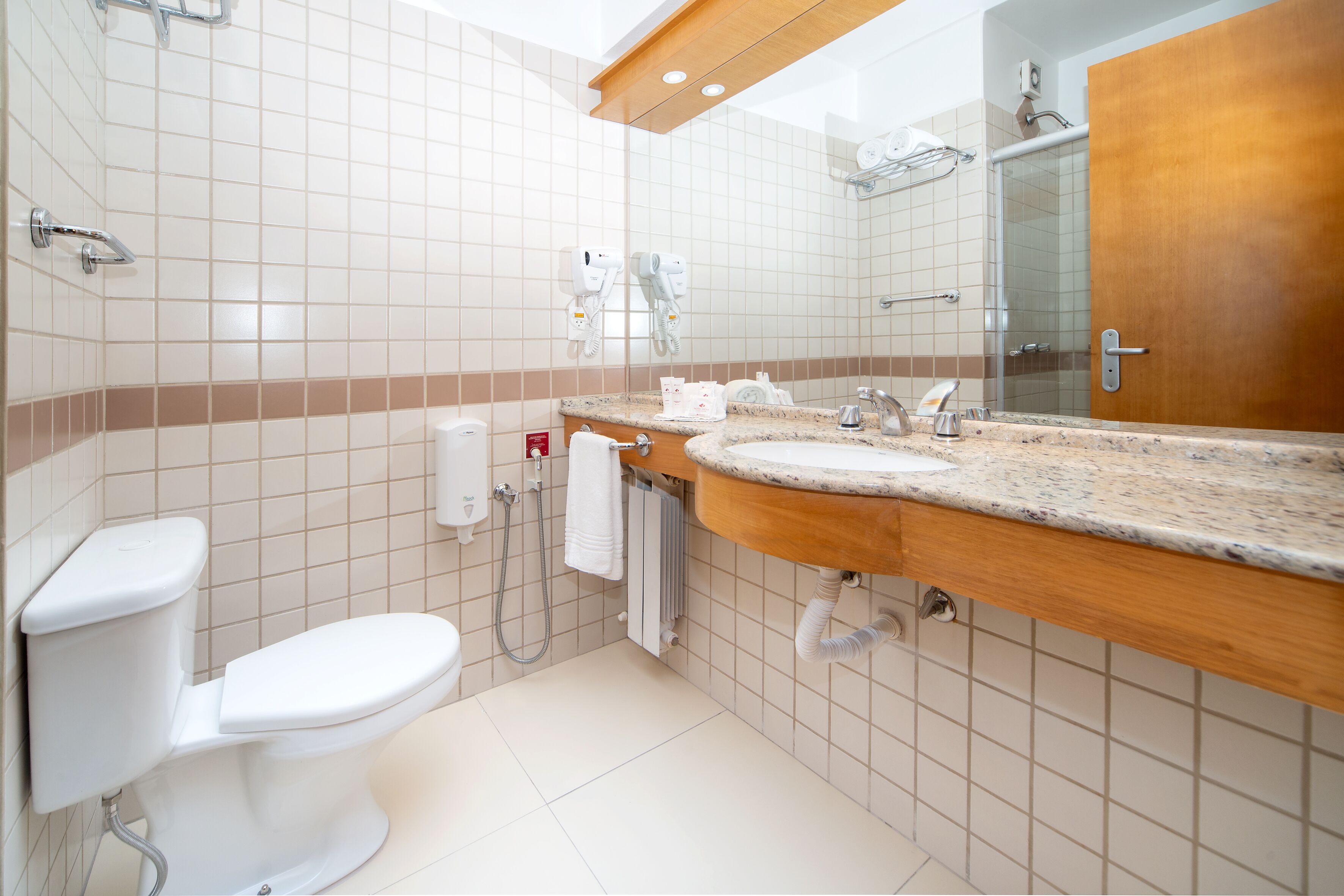A modern bathroom with a toilet, sink, and shower.