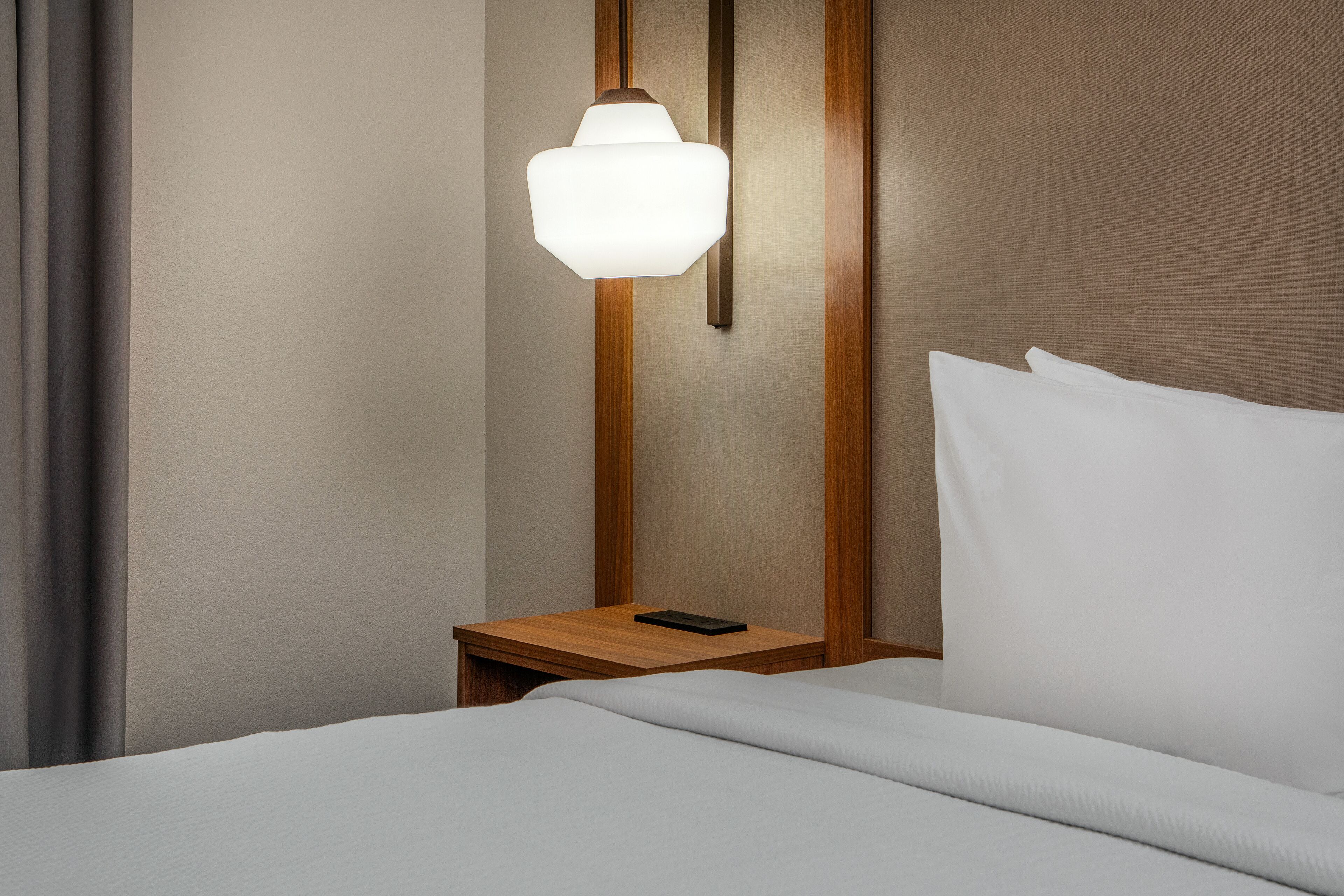 Premium bedding, desk, laptop workspace, blackout curtains