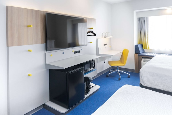 A hotel room with a bed, a desk with a computer, a TV, a small fridge, and a chair. - Microtel Inn & Suites by Wyndham Olean/Allegany (Olean)