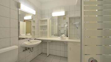 A modern bathroom with a toilet, sink, and mirror.