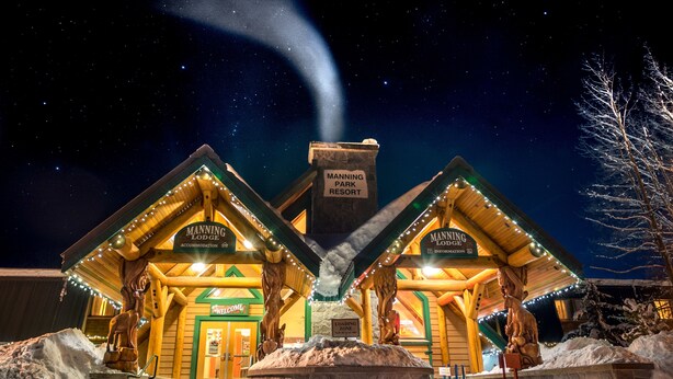 A lodge with a 'Manning Park Resort' sign, wooden architecture, and a 'Welcome' sign. - Manning Park Resort (Manning Park)