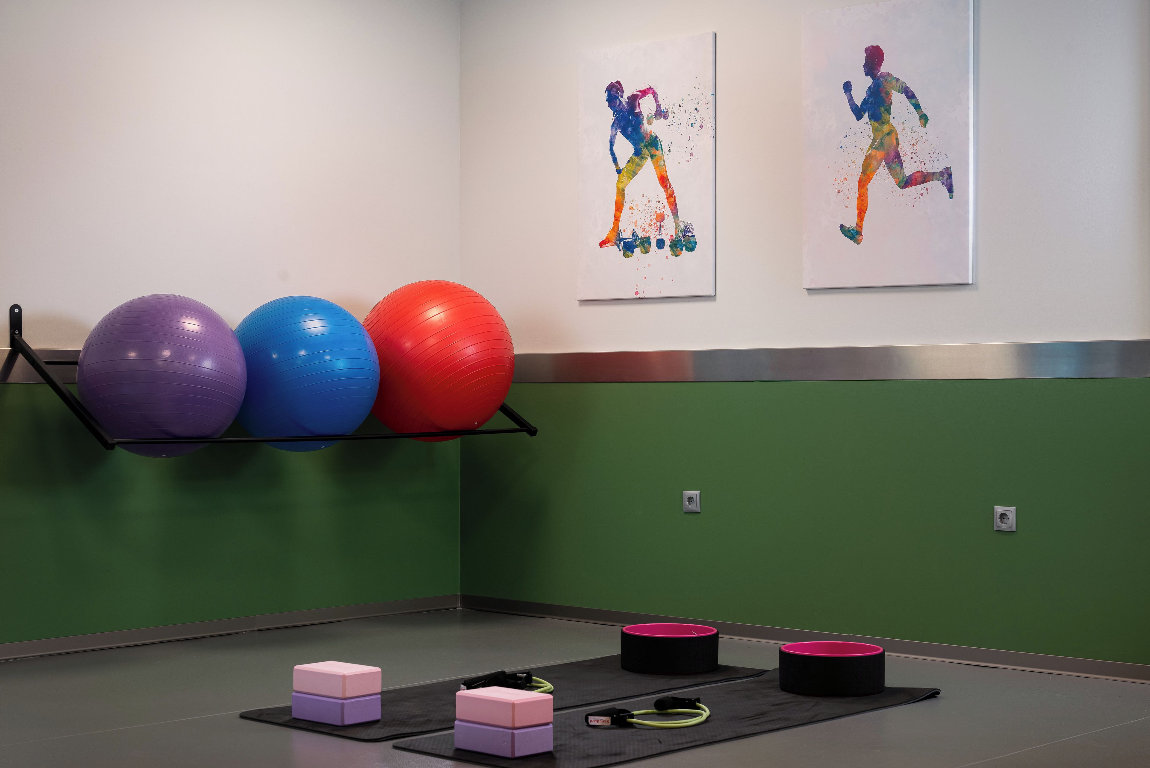 A gym with exercise balls, mats, and fitness equipment.