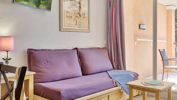 Appartement 6 personnes - 1 chambre - 1 coin nuit - Terrasse ou balcon - Vue jardin | Opholdsområde | Tv, bøger