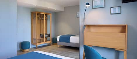A modern bedroom with a large bed, a wooden wardrobe, a desk, and a chair.