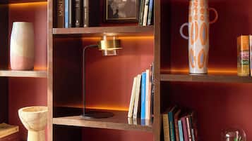 A bookshelf with books, a framed picture, and decorative items.
