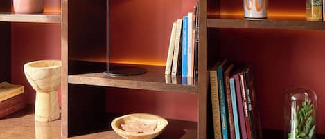 A bookshelf with books, a framed picture, and decorative items.