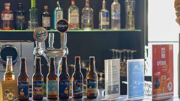 A bar counter with various bottles and a tap labeled 'Heineken Blonde'.