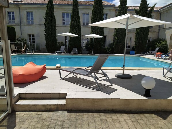 Seasonal outdoor pool, pool umbrellas, pool loungers
