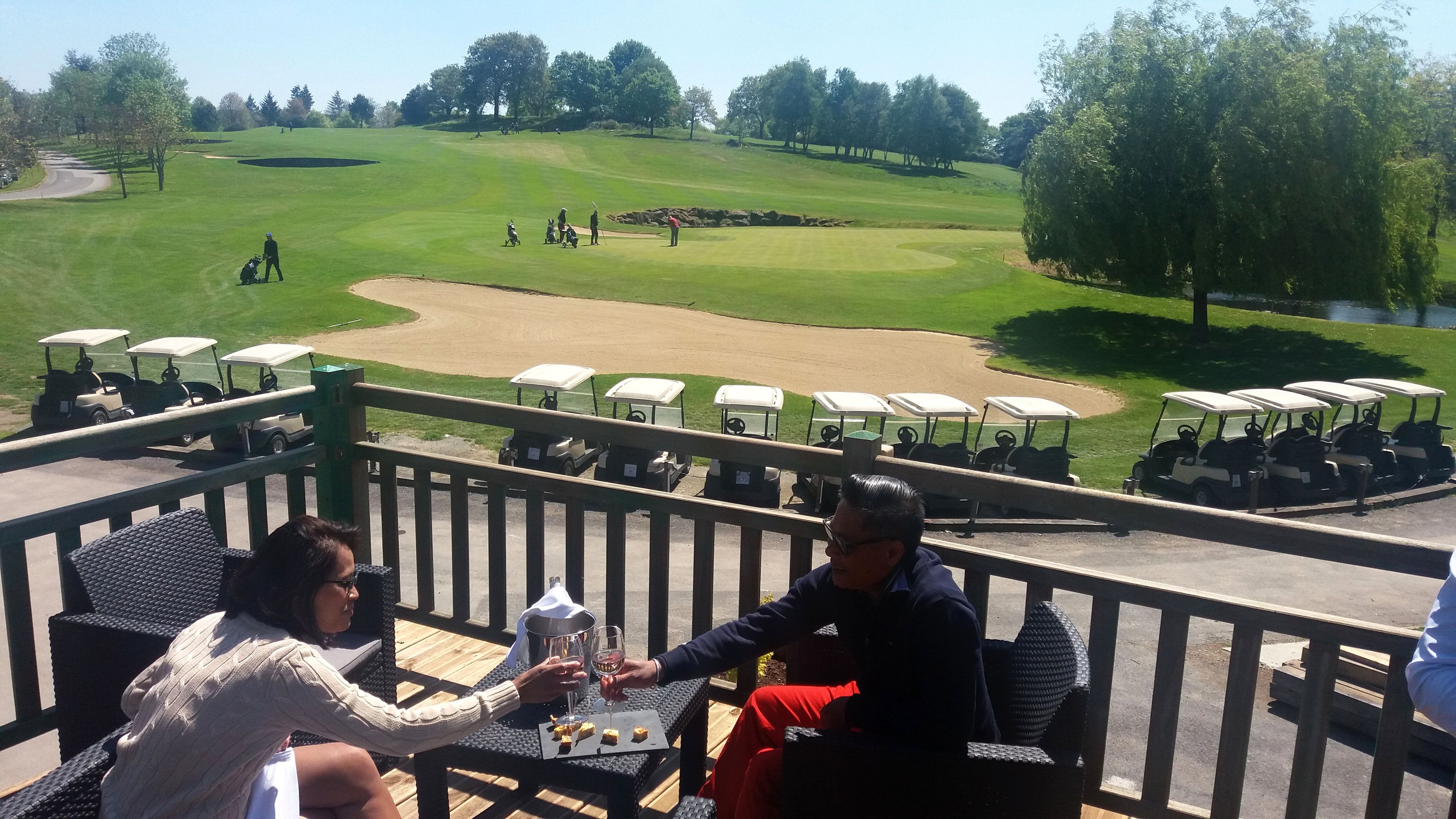 A golf course with a view from a balcony.