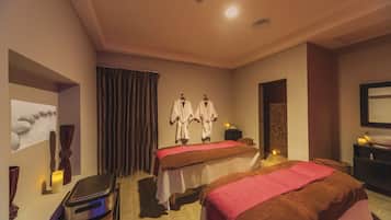 Relax in this serene spa room with two massage tables, a modern sink, and a calming atmosphere.