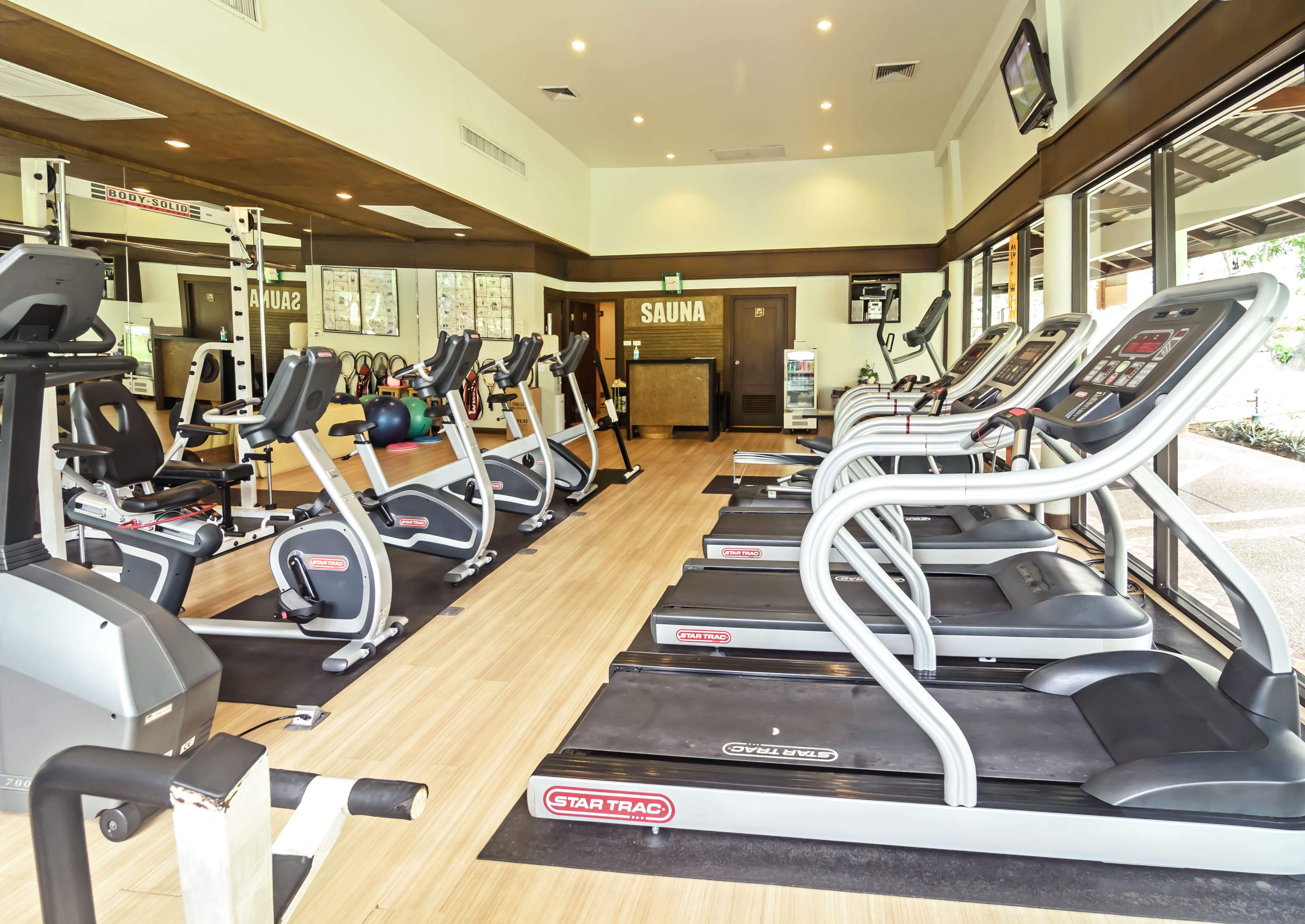 A gym with multiple StarTrac treadmills, weight machines, and a variety of other fitness equipment.