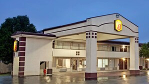 A hotel with a two-story structure, a covered entrance, and a sign indicating it is a Super 8 hotel. - Super 8 by Wyndham Oklahoma/Frontier City (Oklahoma City)