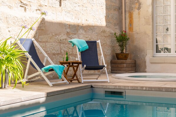 Outdoor pool, open 9:00 AM to 9:00 PM, pool umbrellas, pool loungers