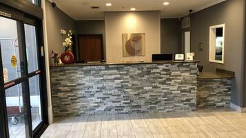 Welcome to our reception area, featuring a stylish desk and abstract art piece.