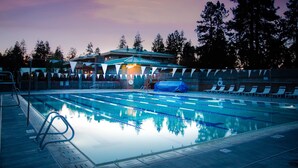 A swimming pool with lane dividers, lounge chairs, and a covered area with a roof. - Mount Bachelor Village Resort (Bend)