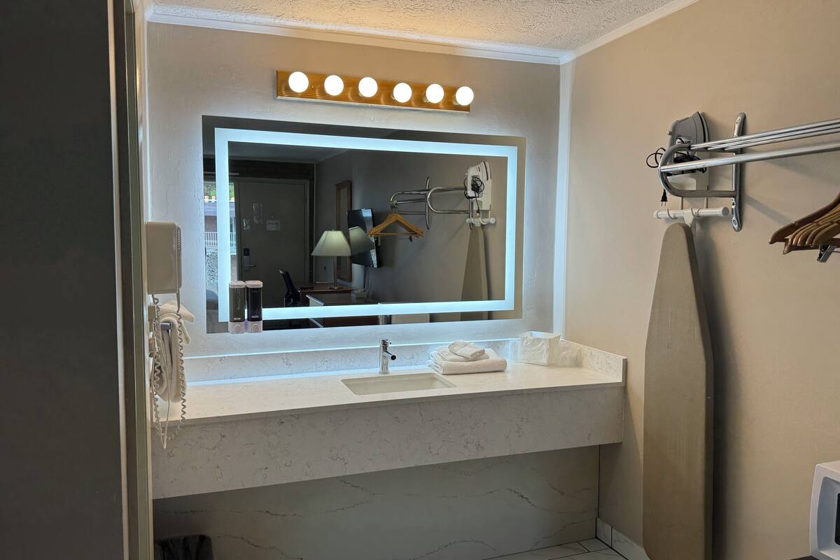 deluxe double room, 2 queen beds, refrigerator & microwave | bathroom sink