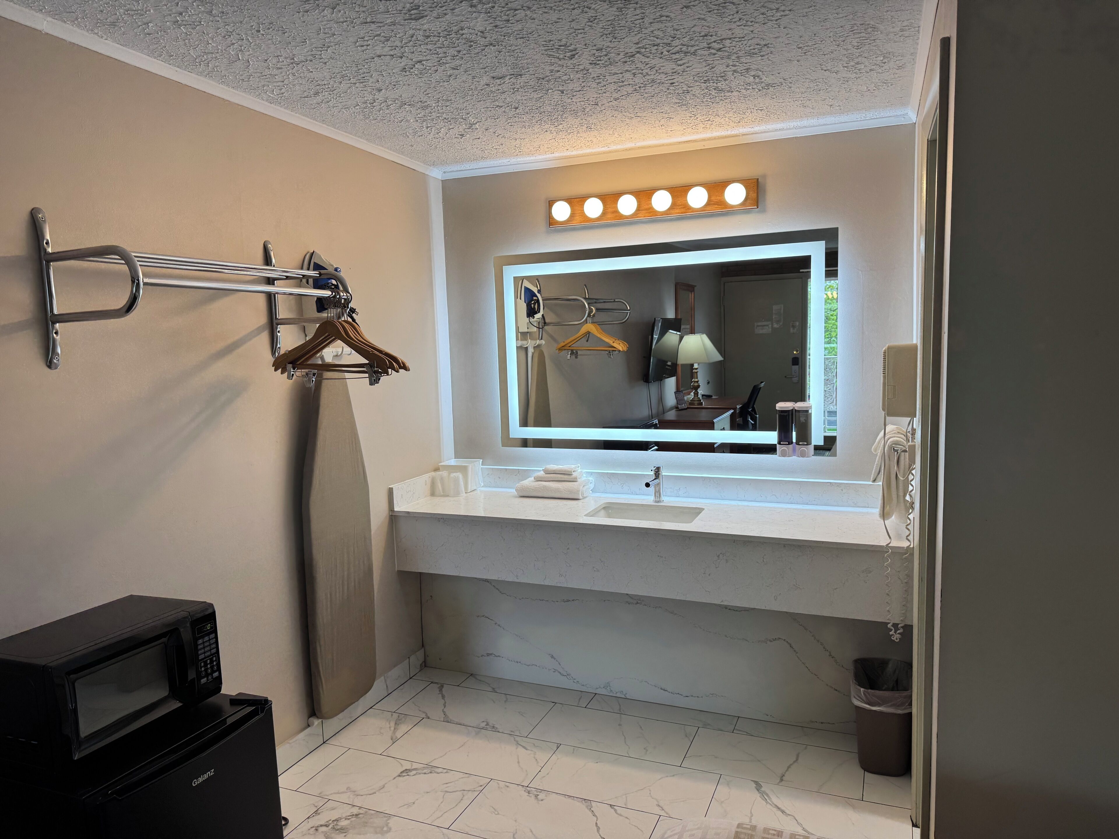 deluxe double room, 2 queen beds, refrigerator & microwave | bathroom sink